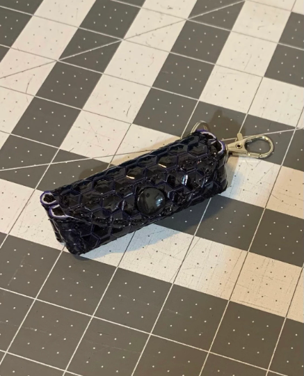 Dark blue (almost black) raised hexagon lip balm keeper keychain