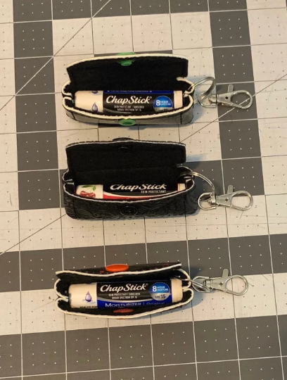 Dark blue (almost black) raised hexagon lip balm keeper keychain